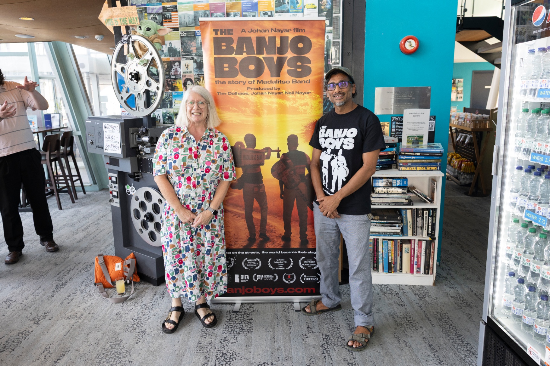 Director Johan Nayar with Susan Beckett beside The Banjo Boys poster at Harbour Lights, Southampton
