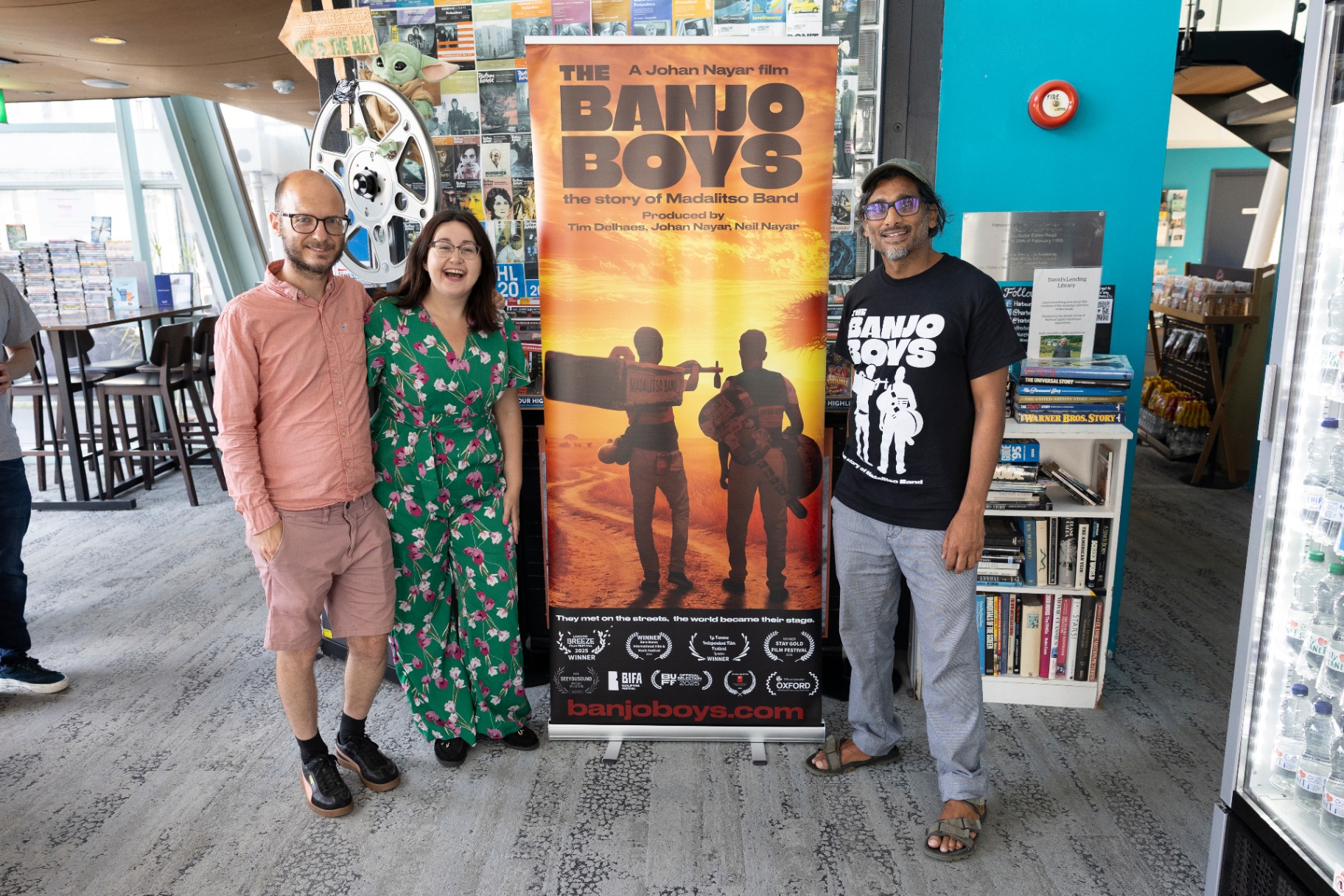 Director Johan Nayar with Gemma beside The Banjo Boys poster at Harbour Lights, Southampton