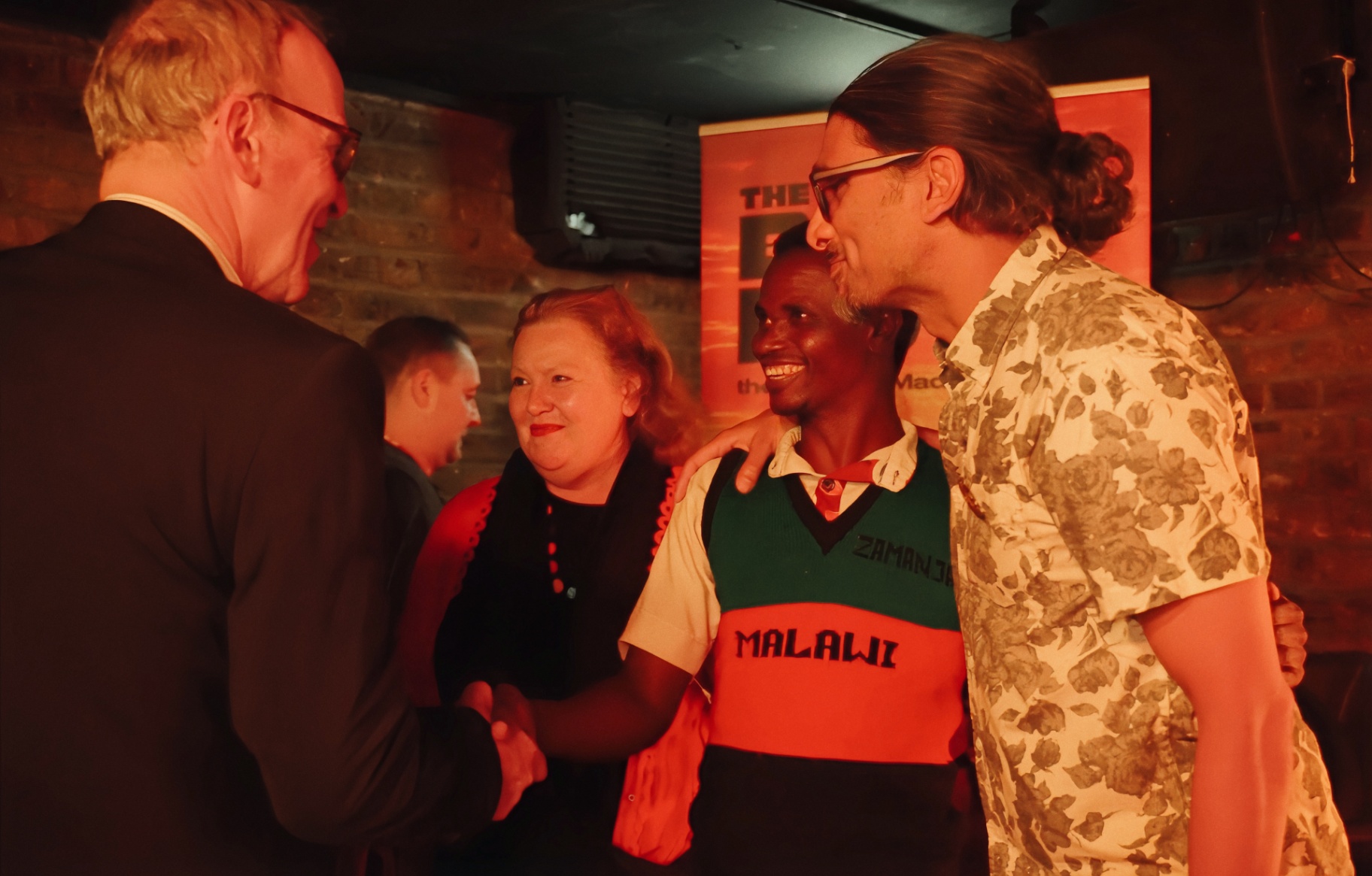 Caroline and Tony Todd greeting Yobu with Johan Nayar at The Madalitso Experience — Caroline and Tony were the primary supporters of the event, alongside Earl's Court Film Festival
