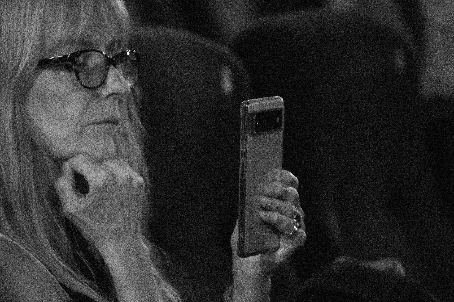 A guest in the audience filming on her phone at The Madalitso Experience at Harbour Lights, Southampton