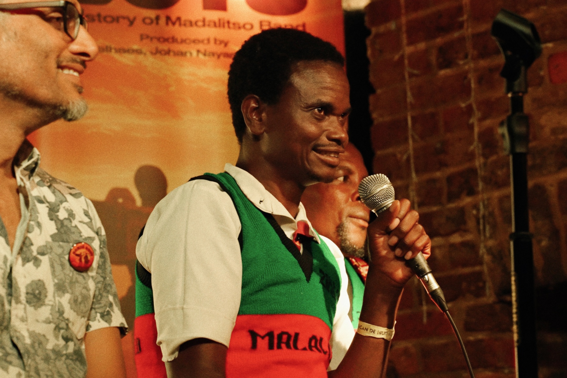 Yobu on the mic with Johan Nayar and a bandmate at The Madalitso Experience at the Troubadour, London