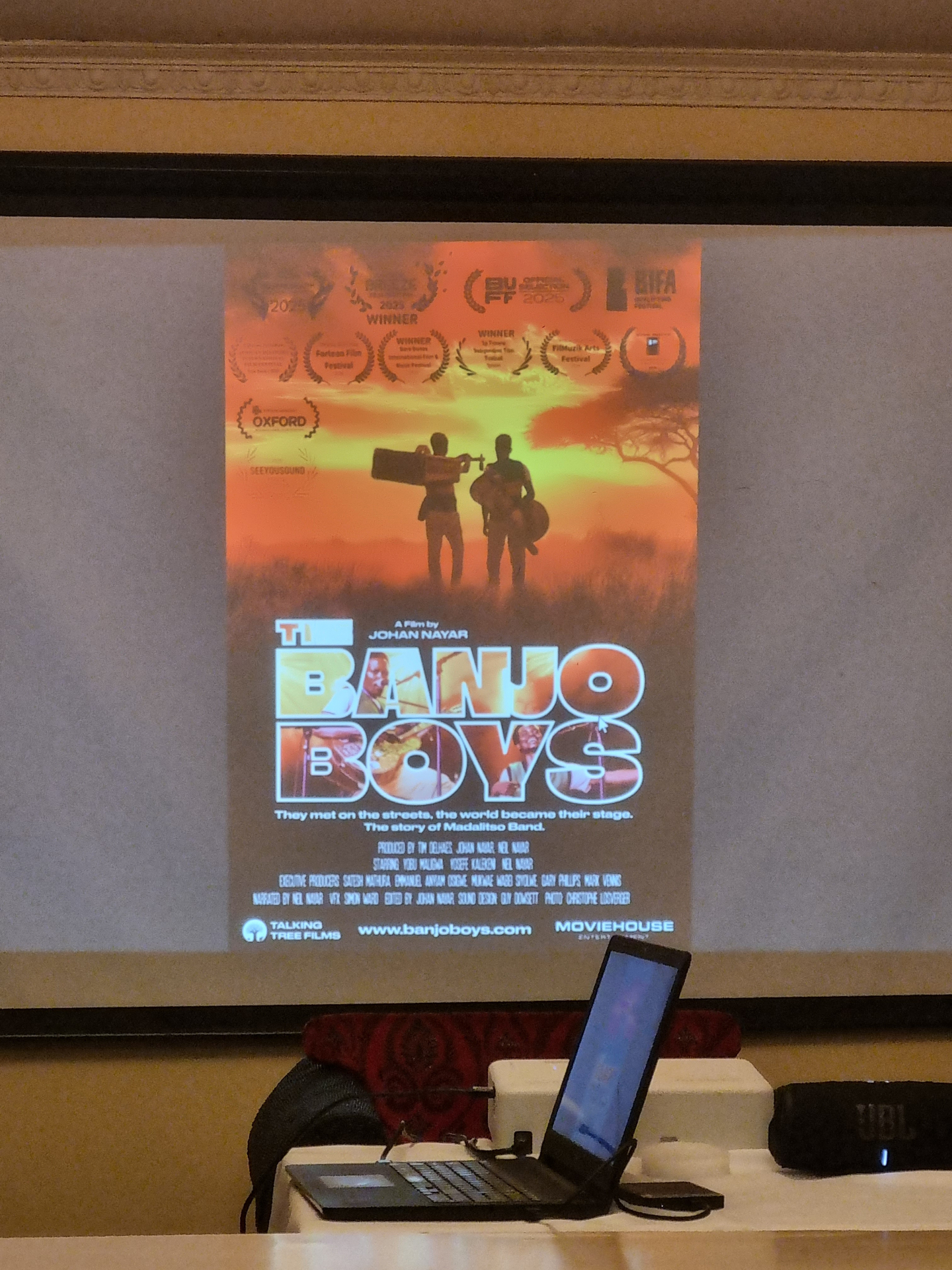 The Banjo Boys poster projected on screen at the Zomba City Festival African Premiere