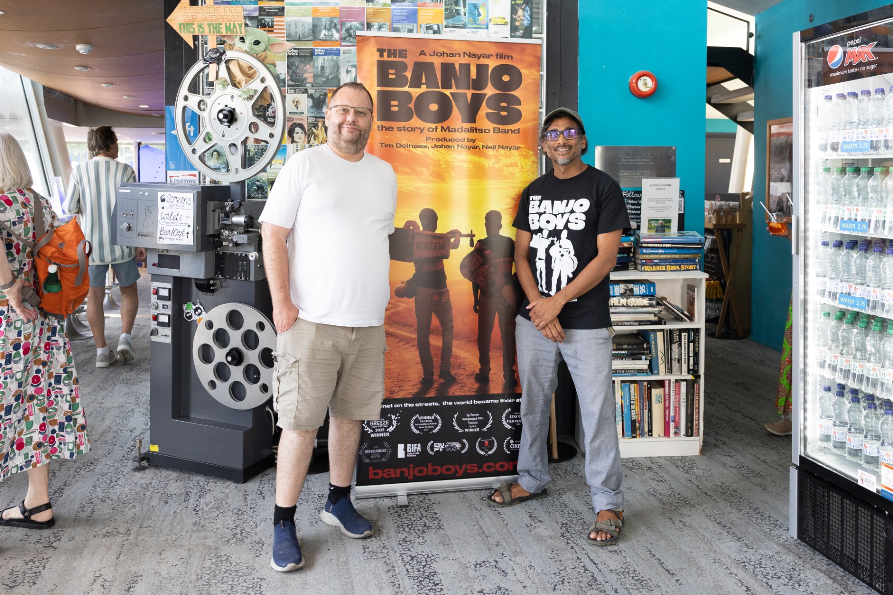 Director Johan Nayar with Oliver Collins beside The Banjo Boys poster at Harbour Lights, Southampton