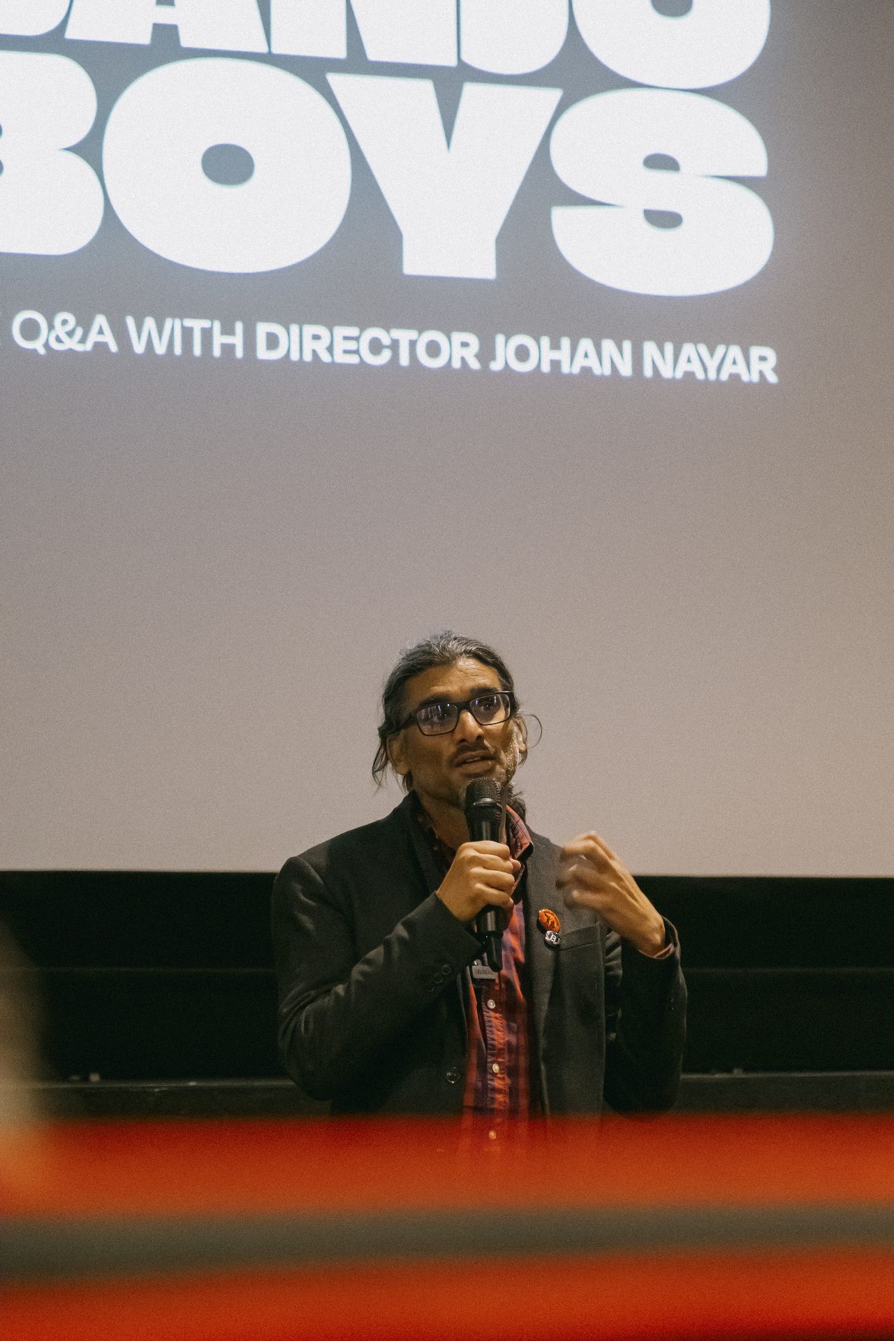 Director Johan Nayar gesturing with the microphone during the Bristol Q&A