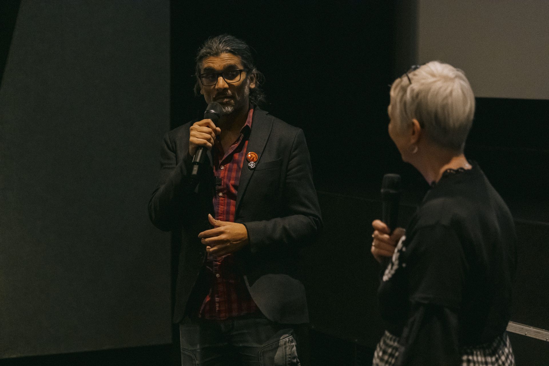 Close-up of director Johan Nayar speaking on stage during the Bristol Q&A