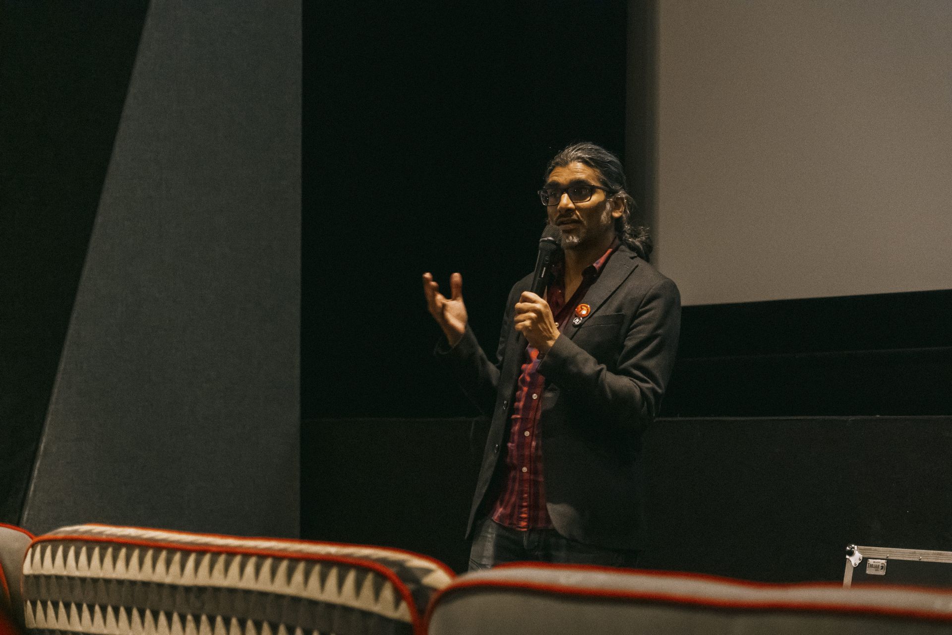 Wide shot of director Johan Nayar on stage at Everyman Bristol