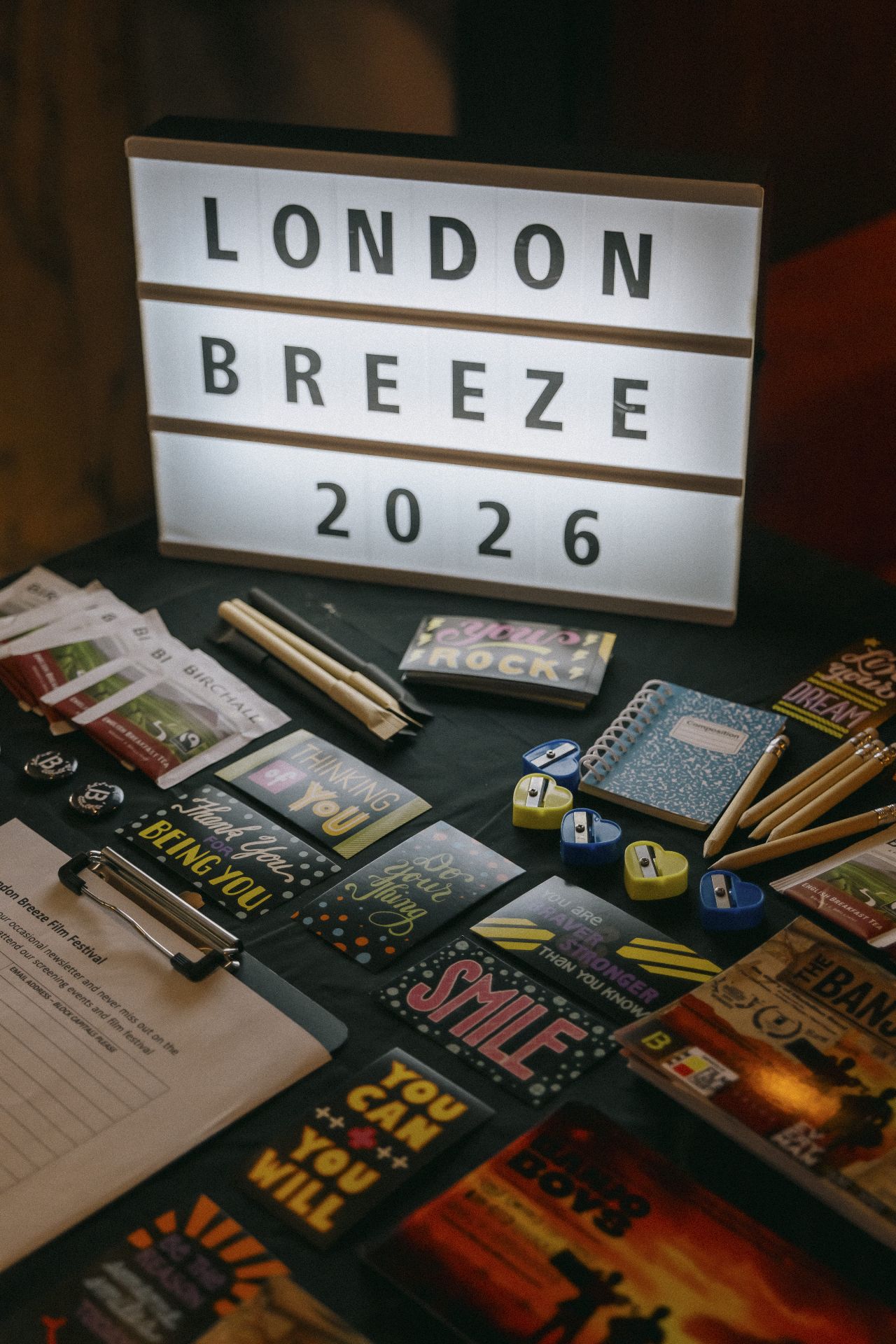 London Breeze 2026 merchandise and Banjo Boys flyers on the festival table in Bristol
