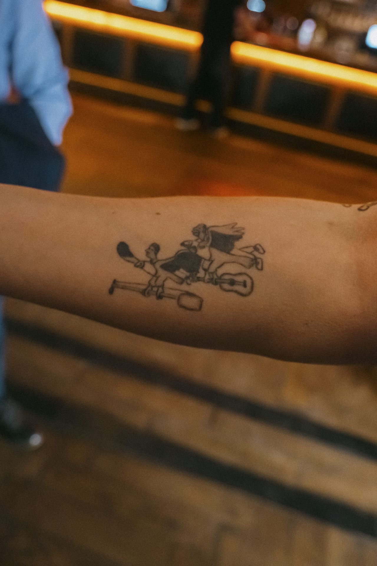 Close-up of a Banjo Boys-inspired tattoo on a guest's arm at the Bristol screening