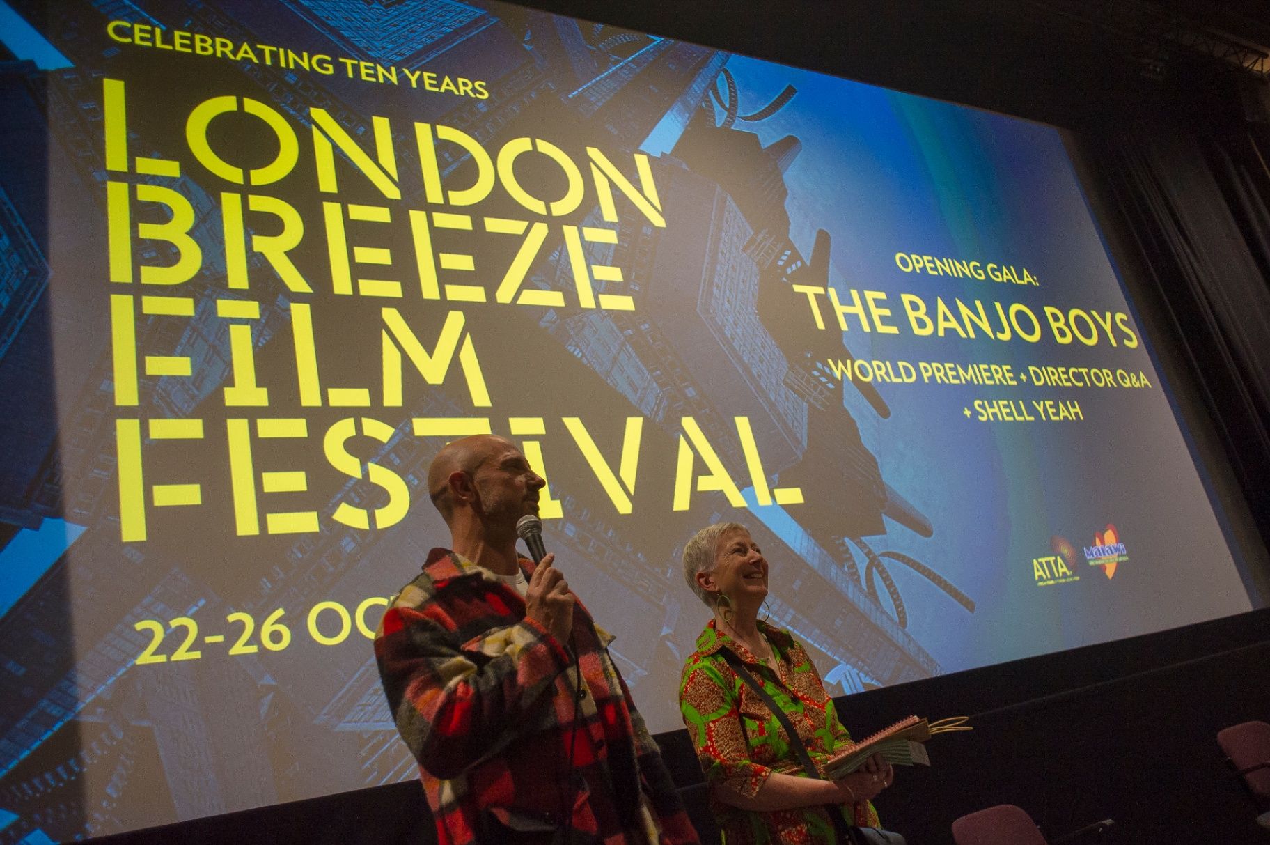 Sam Cullis and Madeleine Casey introducing the opening gala at the London Breeze world premiere — 22 Oct 2025