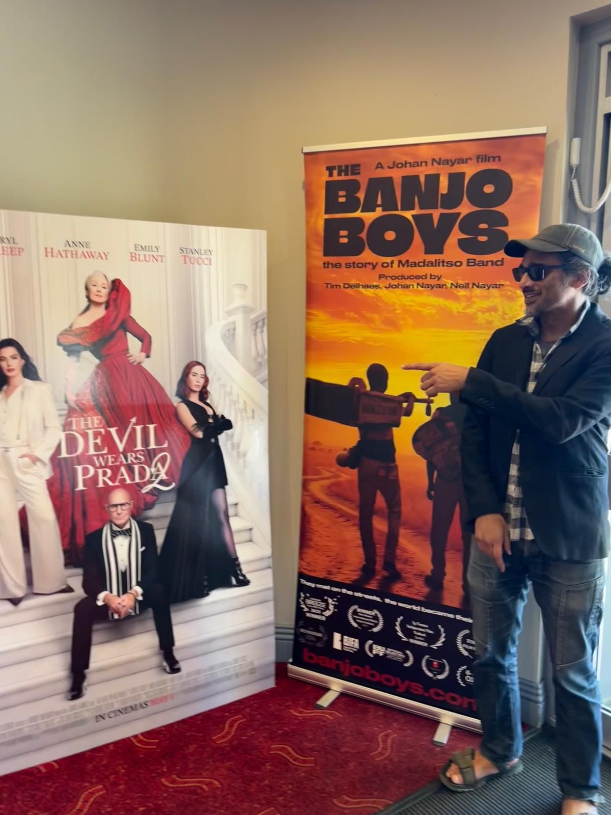 Director Johan Nayar with The Banjo Boys foyer banner at Savoy Cinema, Nottingham
