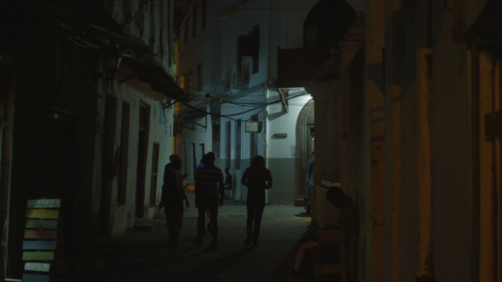 Neil, Yobu and Yosefe walking the streets of Stone Town, Zanzibar